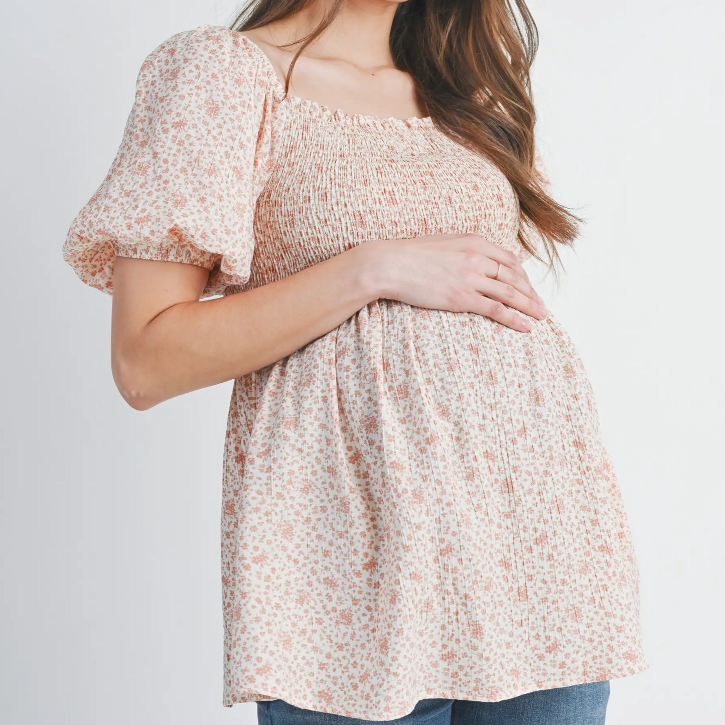 Close-up of smocked bodice and floral pattern on maternity top