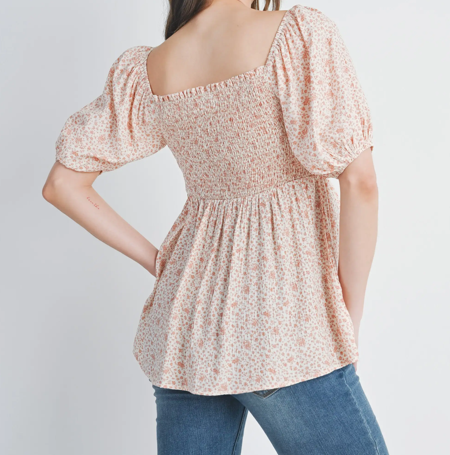 Back view of bubble sleeve floral maternity shirt