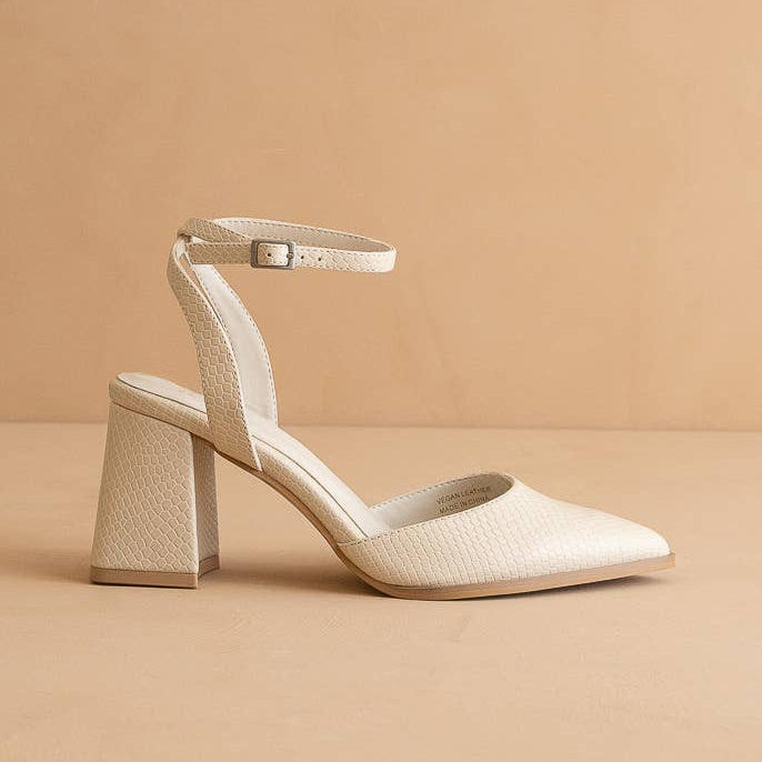 Beige high-heeled shoe on a beige background