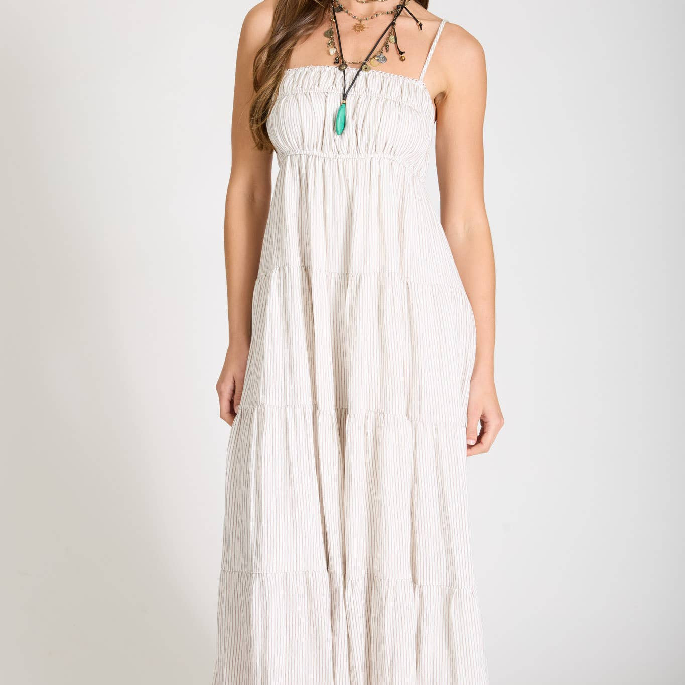 Woman wearing a white dress against a plain background