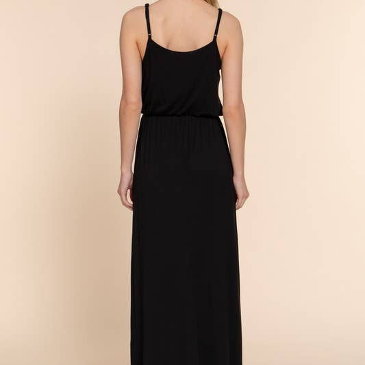 Woman wearing a black dress against a beige background