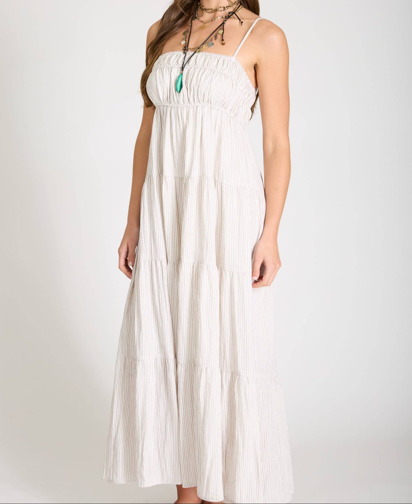 Woman wearing a white dress against a plain background