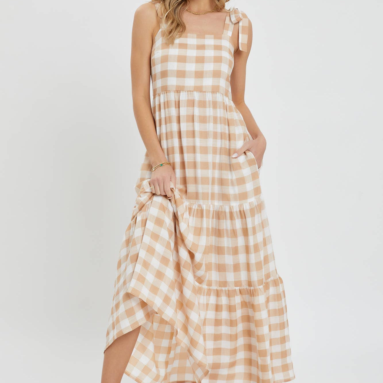 Woman wearing a checkered dress on a white background