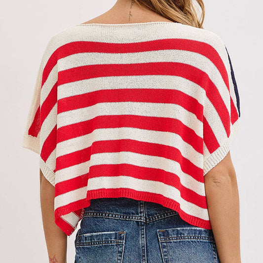 Person wearing a red and white striped sweater and denim skirt on a plain background