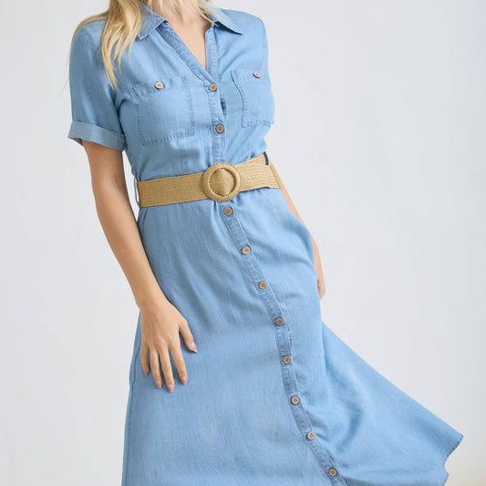 Woman wearing a blue denim dress with a beige belt on a white background