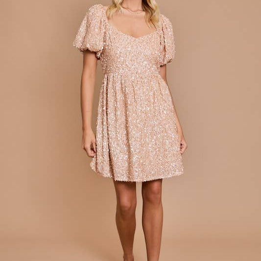 Woman wearing a beige floral dress against a beige background