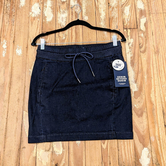 Flat lay of denim skort showcasing waistband and structure