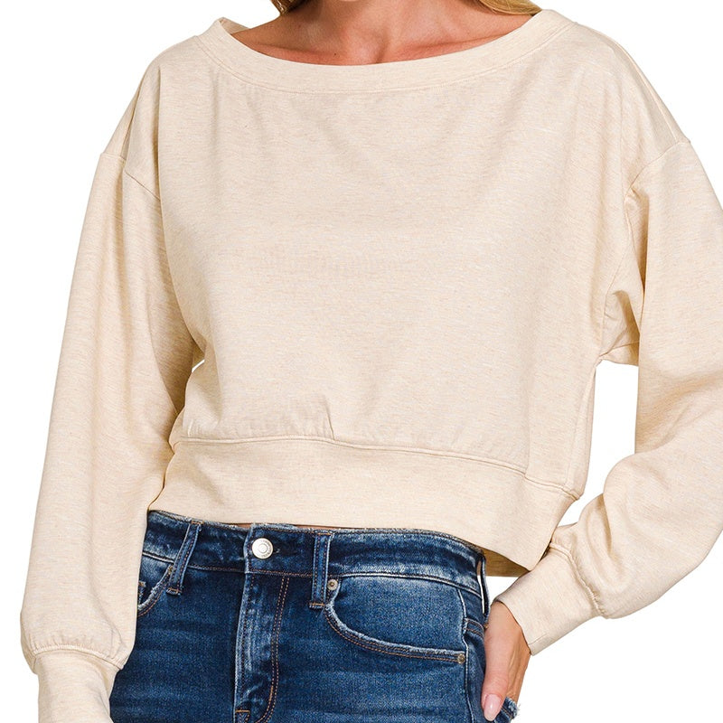 Beige sweatshirt worn by a person on a white background