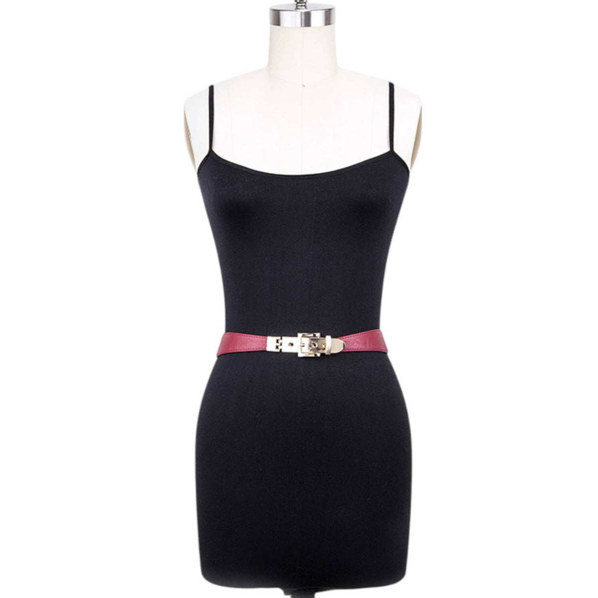 A black spaghetti-strap mini dress displayed on a white dress form mannequin, featuring a thin pink belt with a silver buckle at the waist.