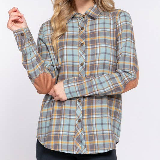 Woman wearing a plaid shirt against a white background