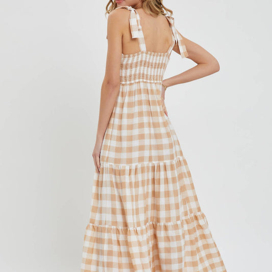 Woman wearing a checkered dress on a white background