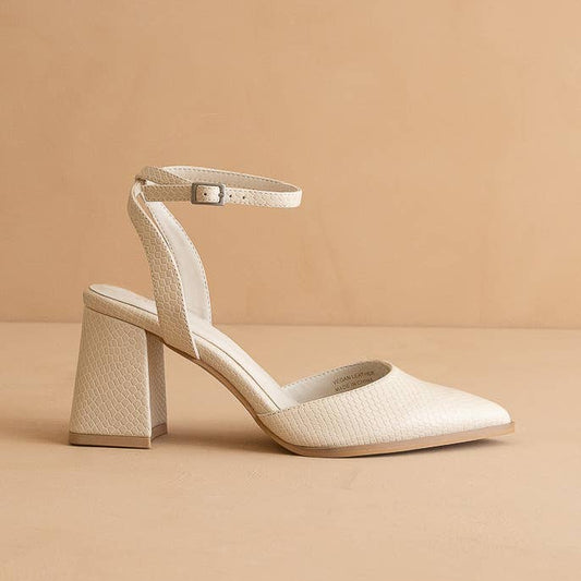 Beige high-heeled shoe on a beige background