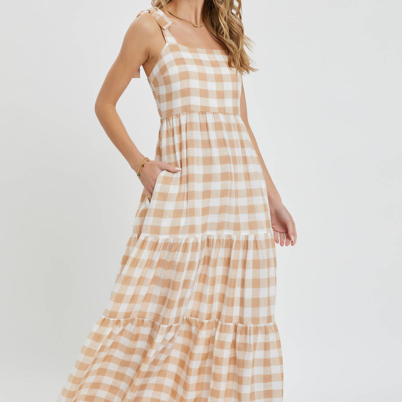 Woman wearing a checkered dress on a white background